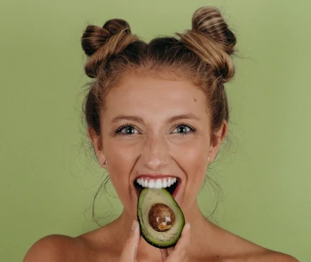 happy woman eating avocado